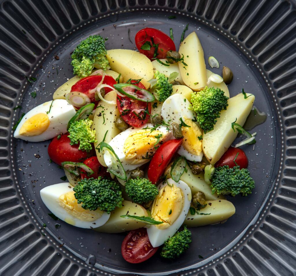 Potato salad with egg and vegetables